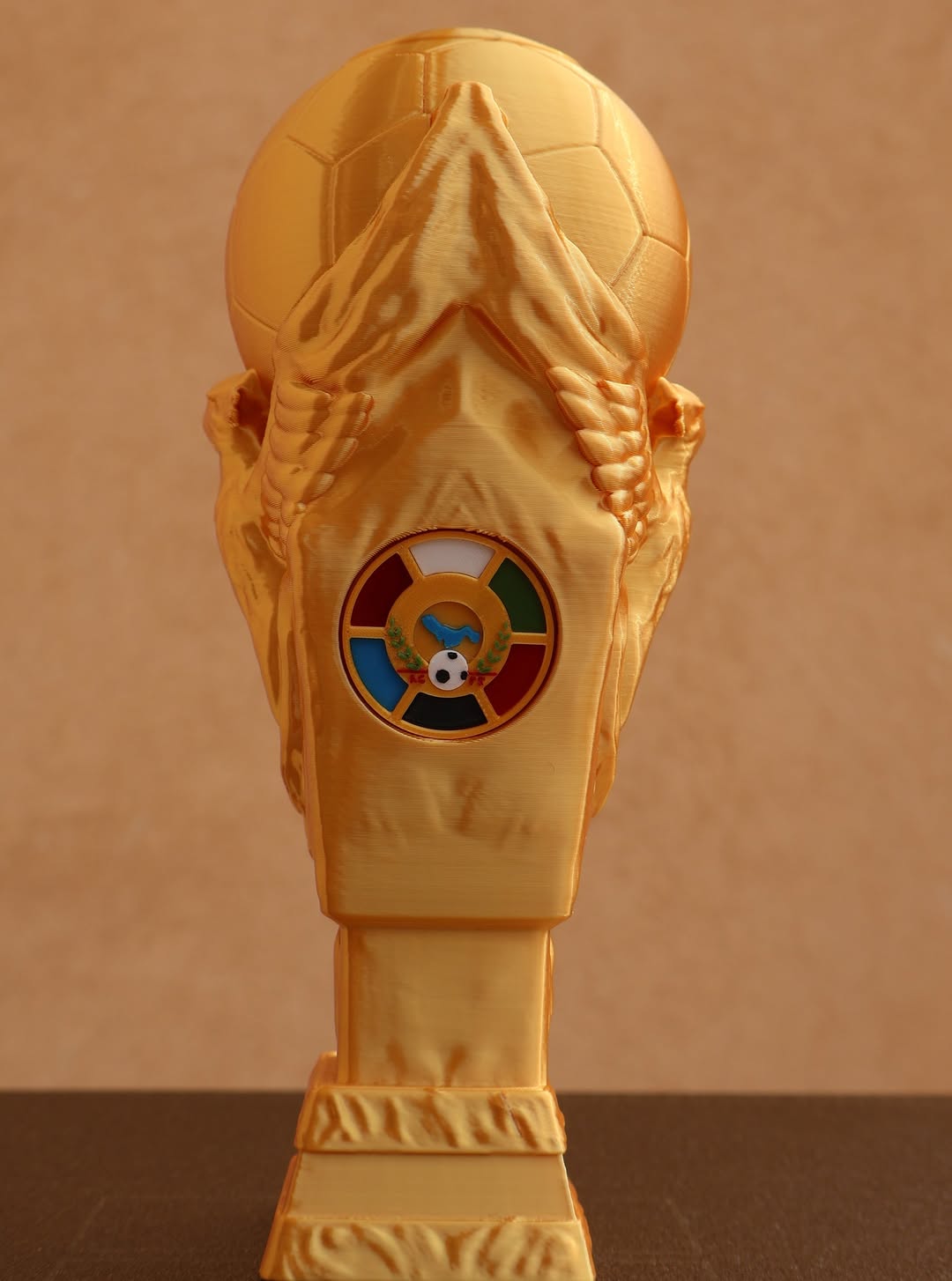 Gold 3D printed Gulf Cup trophy replica with emblem detail